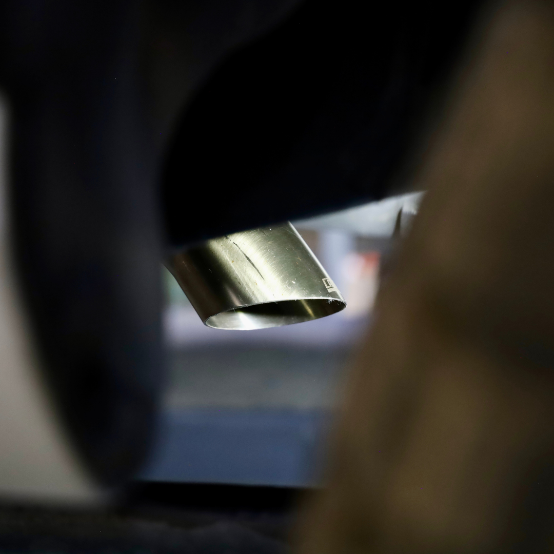 A close up of the end of an installed 2024-2025 Toyota Tacoma Carven Exhaust Max Clearance Dump Exit Kit