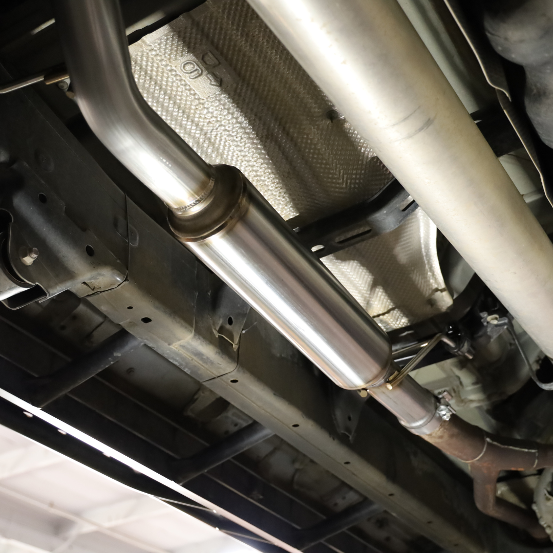 Underside of a car showing an installed 2022-2025 Toyota Tundra Carven Exhaust Signature Clamp Back Kit
