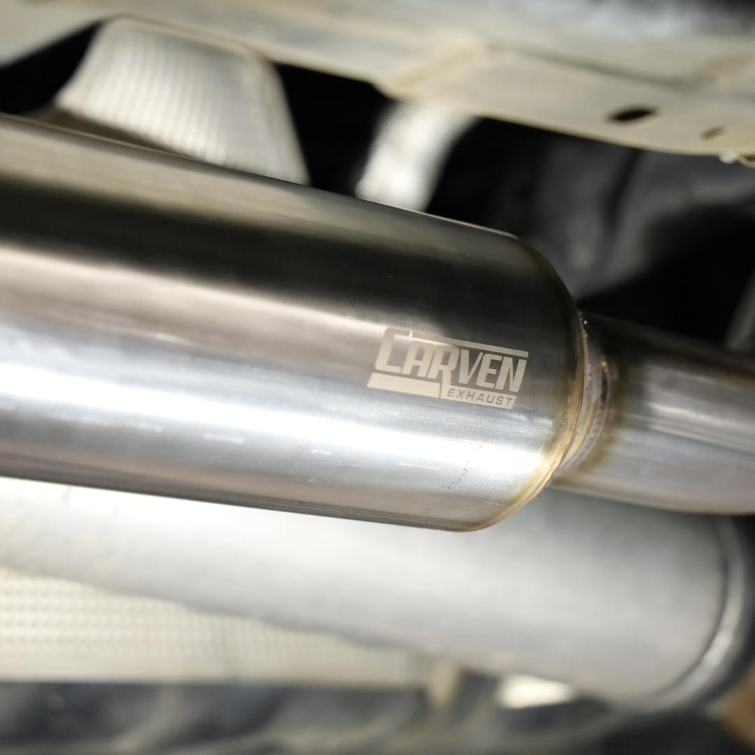 A close up of the installed 2022-2025 Toyota Tundra Carven Exhaust Signature Clamp Back Kit showing the Carven Exhaust logo
