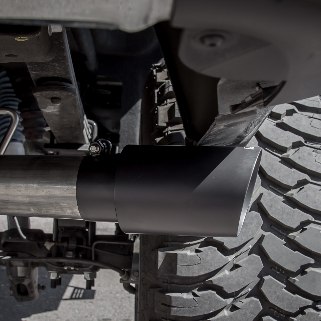 A close up of an installed Carven Exhaust 4.00" Universal Bolt-On Exhaust Tip in cerakote black color