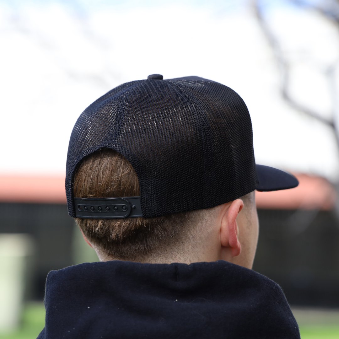Back view of a man wearing a black snapback hat