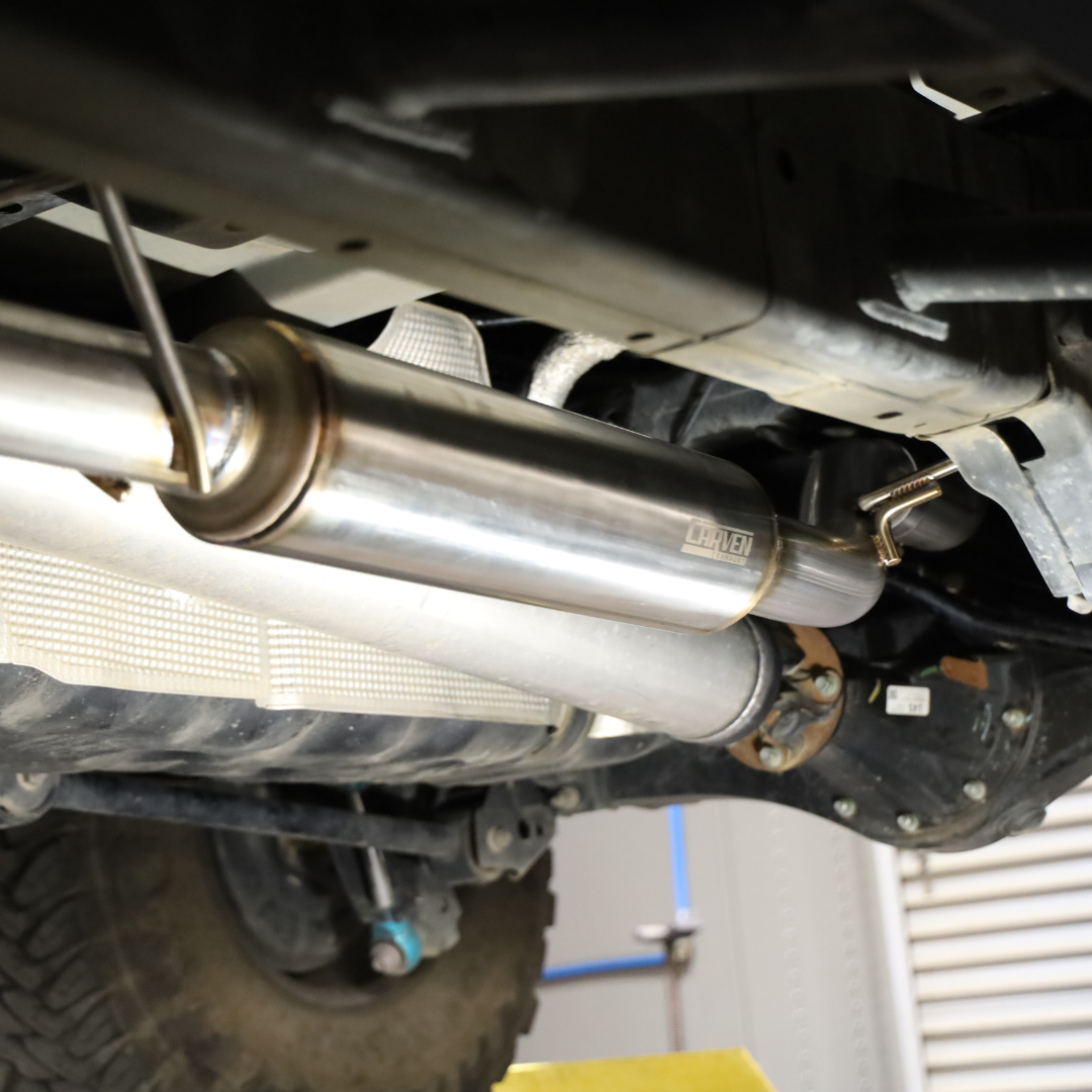 Another angle of the underside of a vehicle with the installed 2022-2025 Toyota Tundra Carven Exhaust Signature Clamp Back Kit