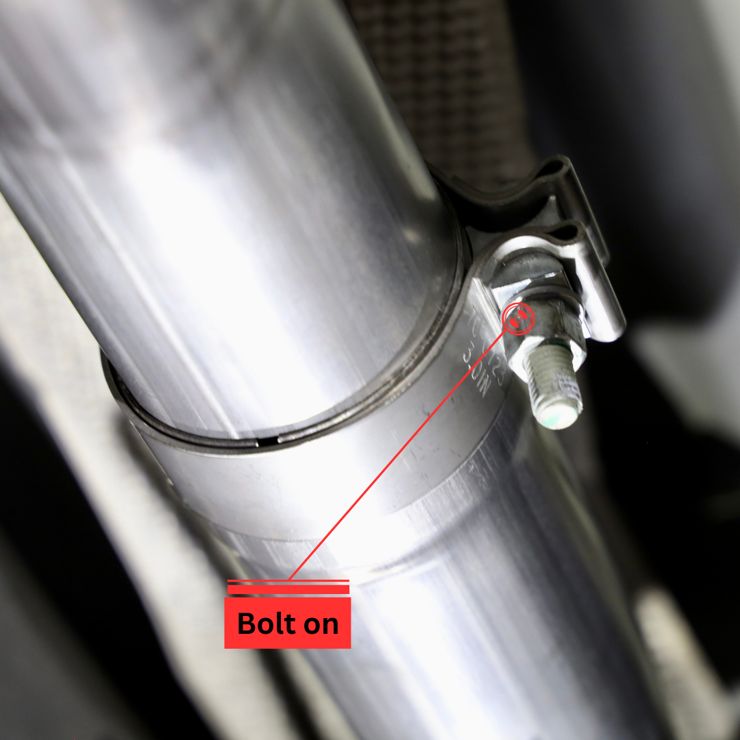 A close up of a bolt and screw on an installed 2019-2023 Ford Ranger Over Axle Carven Exhaust Dump Kit with text that says "Bolt on"