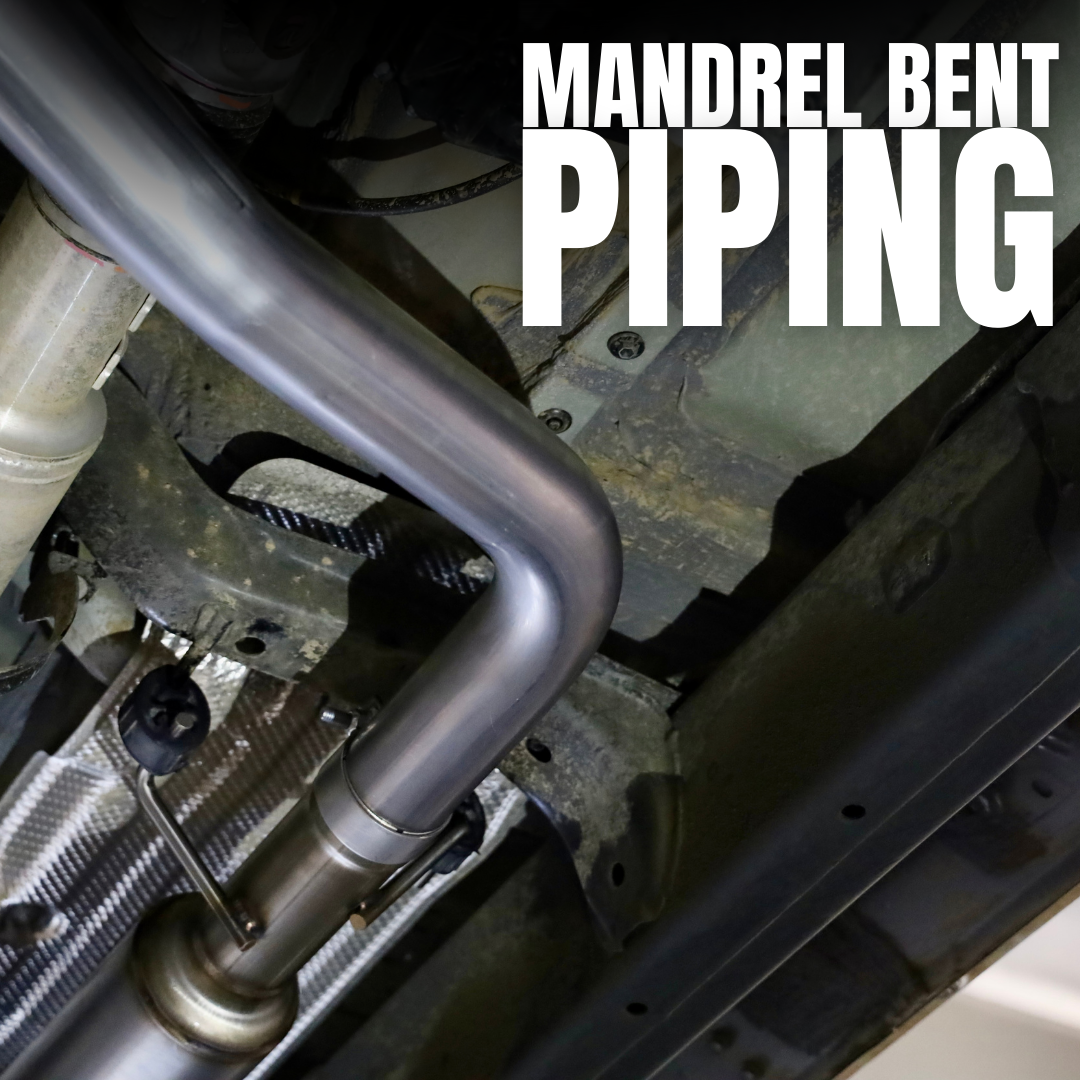 A close up of an installed 2024-2025 Toyota Tacoma Carven Exhaust Max Clearance Dump Exit Kit and text that reads "Mandrel bent piping"
