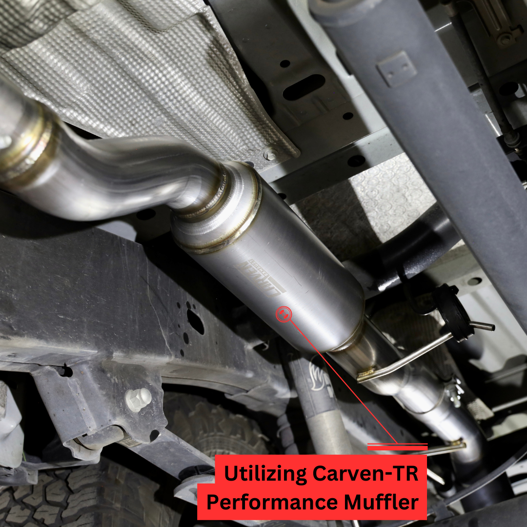 A close up of an installed 2019-2023 Ford Ranger Over Axle Carven Exhaust Dump Kit on the underside of a vehicle with text that says "Utilizing Carven-TR Performance Muffler"