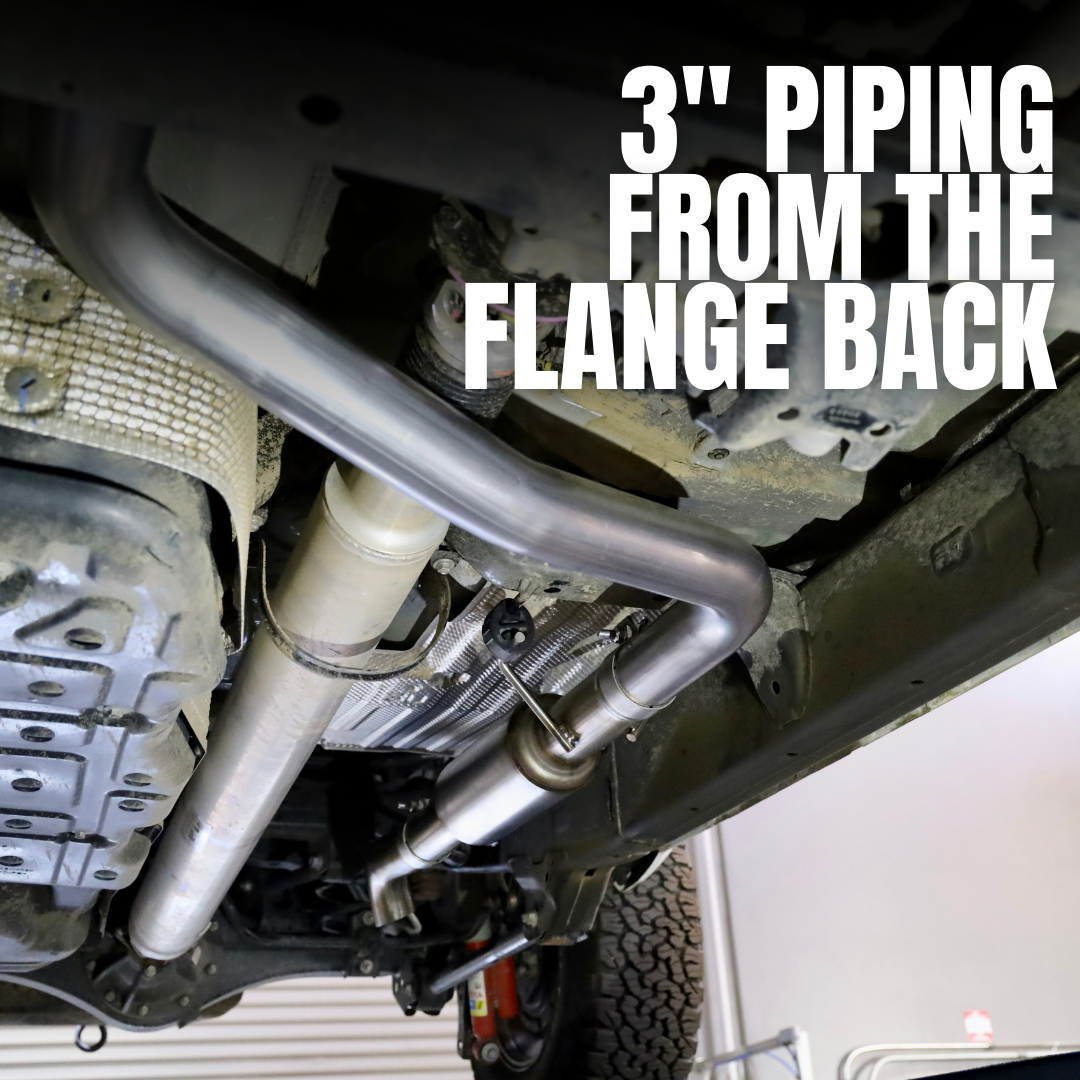 A 2024-2025 Toyota Tacoma Carven Exhaust Max Clearance Dump Exit Kit installed under a vehicle with text that reads "3 inch piping from the flange back"