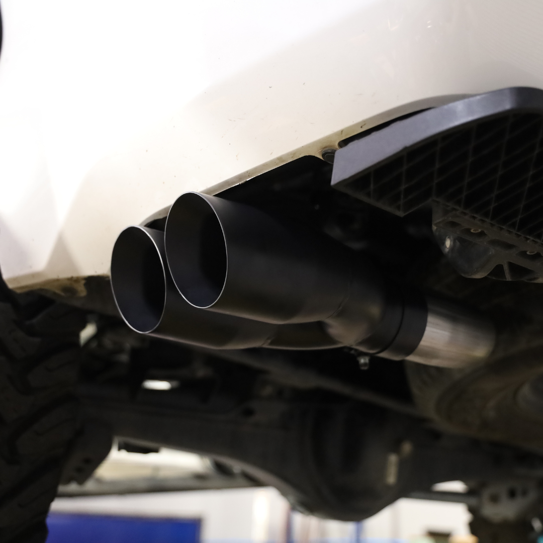 A close up photo of the ends of the installed 2022-2025 Toyota Tundra Carven Exhaust Signature Clamp Back Kit