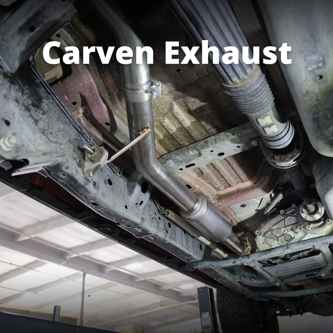 The underside of a vehicle with an installed 2020-2025 Jeep Gladiator Carven Exhaust Over Axle Dump Exit Exhaust System and text that says "Carven Exhaust"