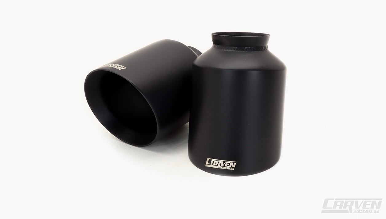Product photo showing the front and top of a 2015-2023 Dodge Charger Carven Exhaust 5.0" Tip Replacement Set in the ceramic coated black color