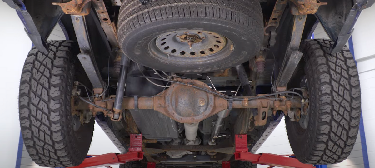 Underside of a truck with an installed 2010-2024 Silverado & Sierra 1500 Carven Exhaust competitor Series Dump Exit Exhaust System