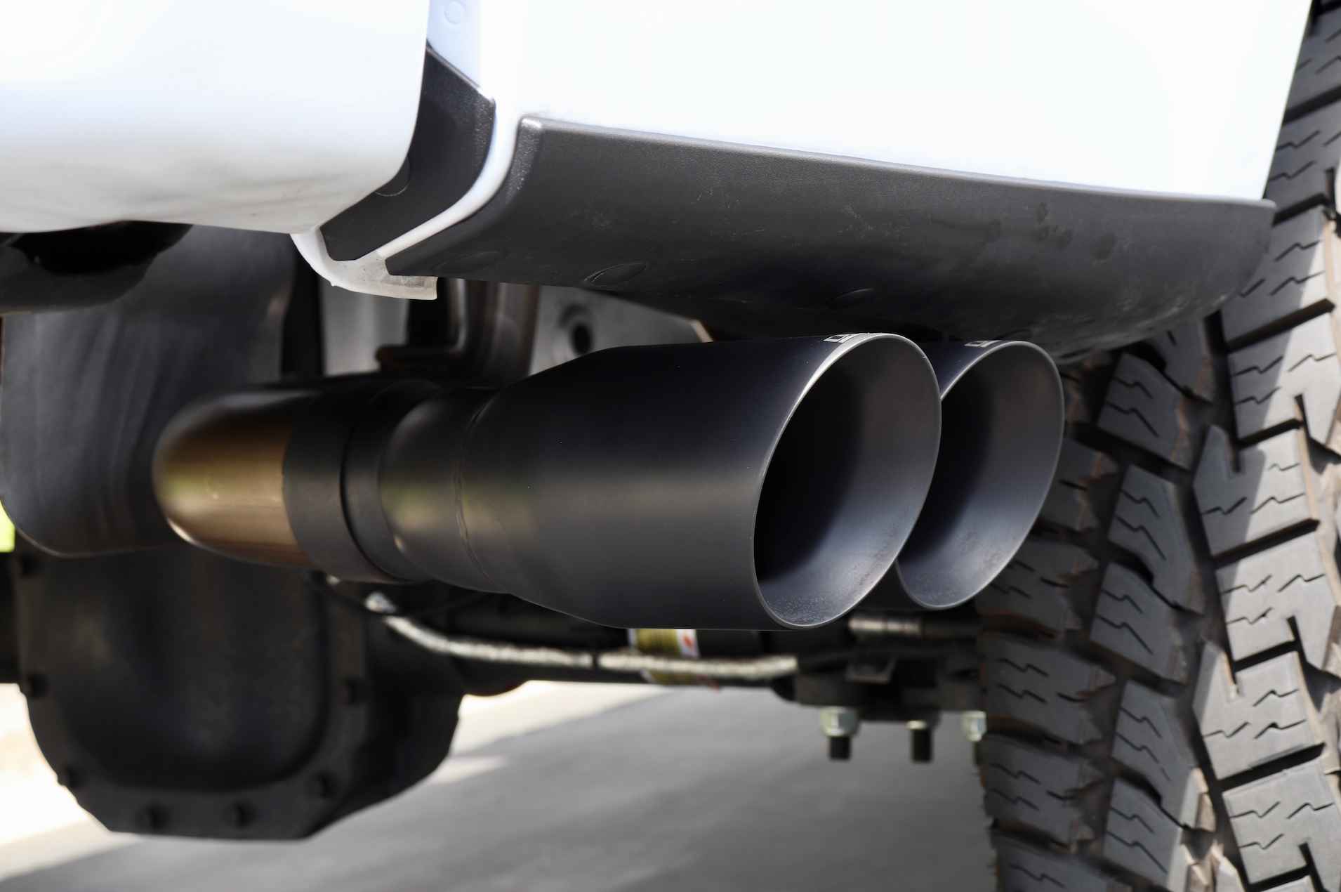 An alternate close up of installed Dual Exit Tips in the Cerakote black color