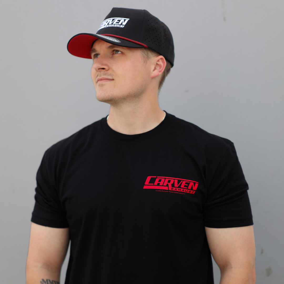 A man modeling a black shirt with a red Carven Exhaust logo on the front and a black Carven Exhaust hat