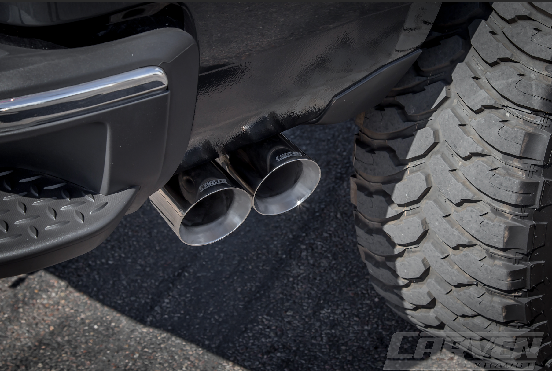 Close up of a Polished 4.0” Dual Exit Stainless Steel Tip installed on a truck