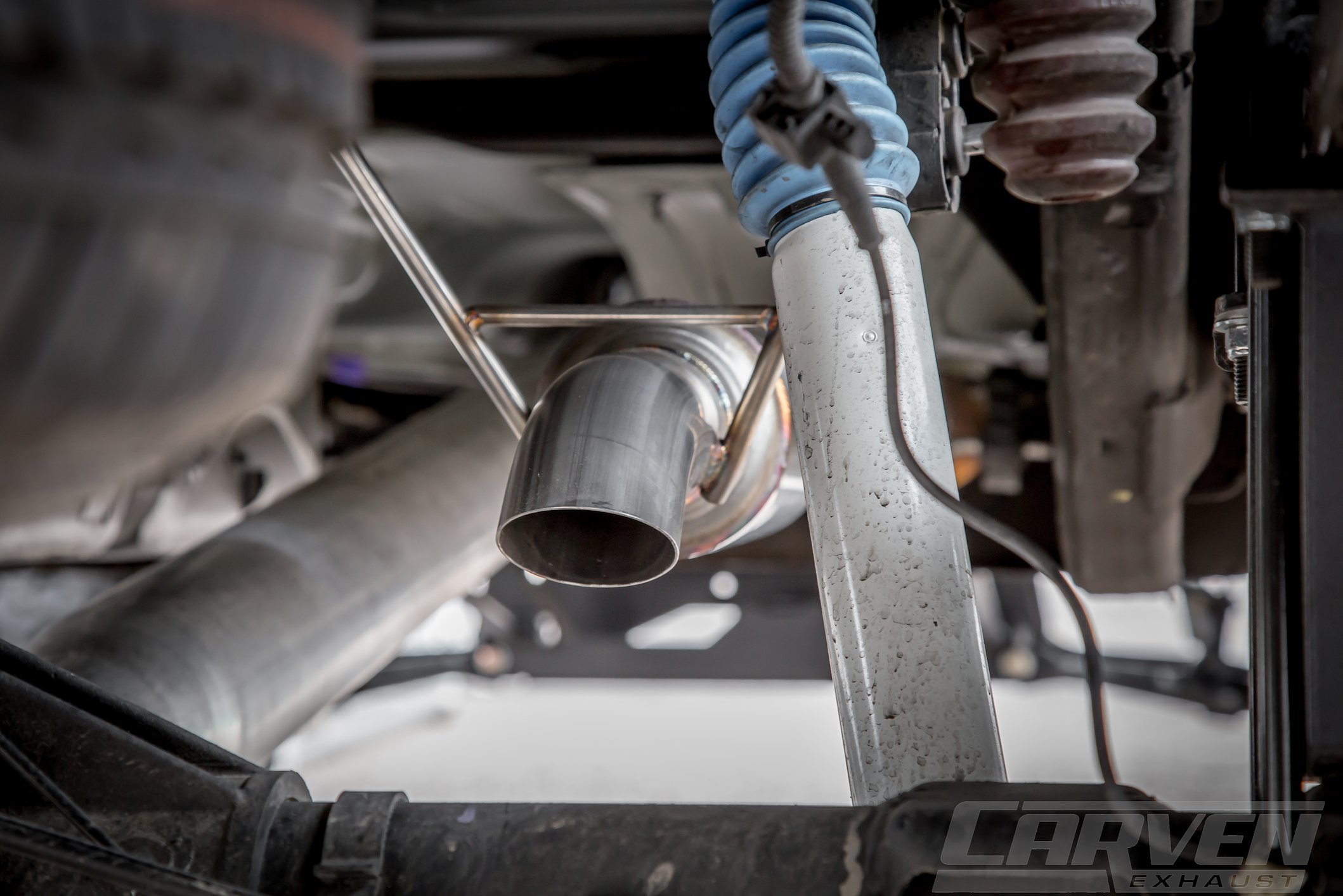 Close up of an installed 2010-2024 Silverado & Sierra 1500 Carven Exhaust progressive Series Dump Exit System
